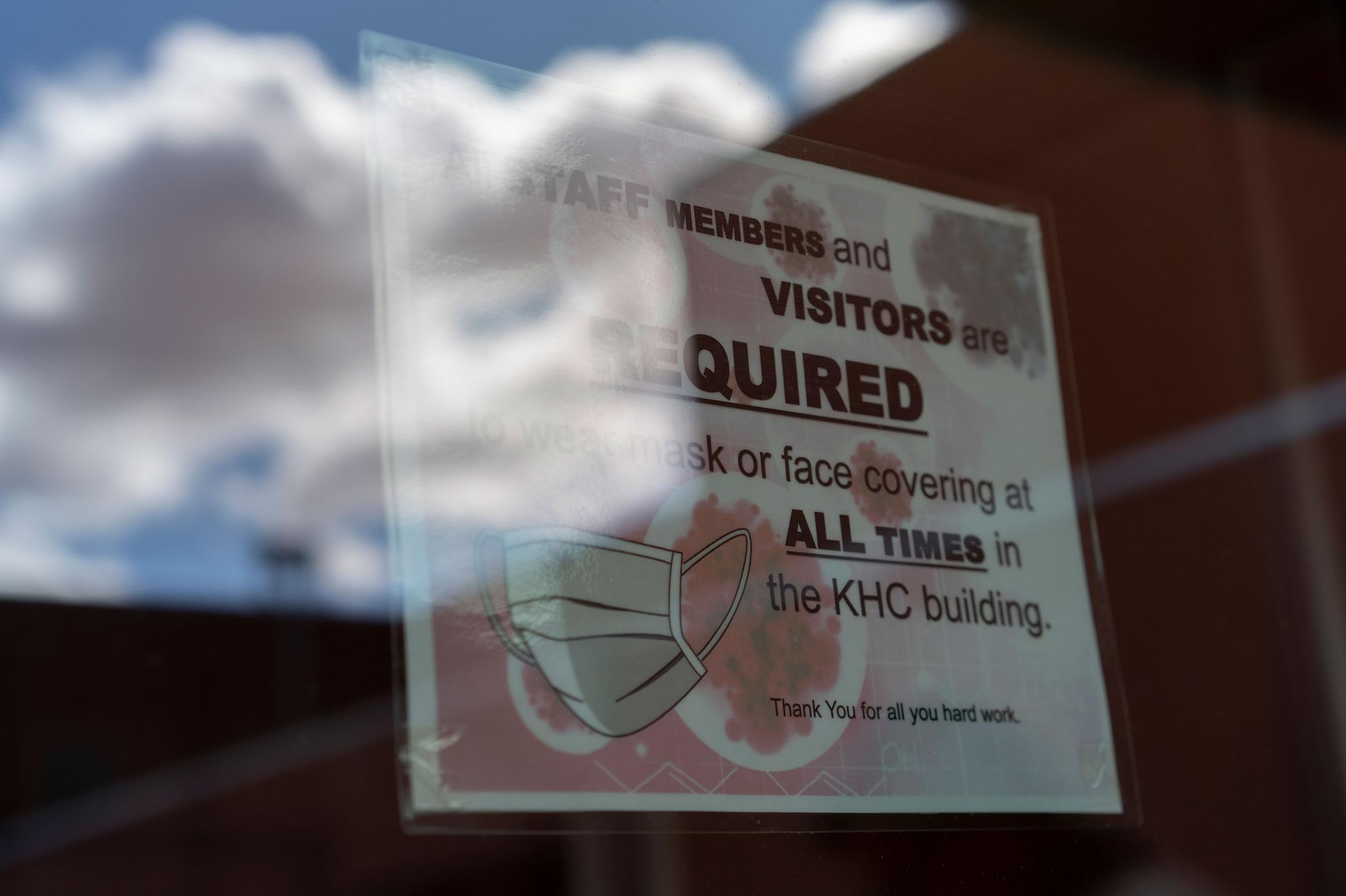a sign warns people to wear face coverings at a Health Center on the Navajo reservation