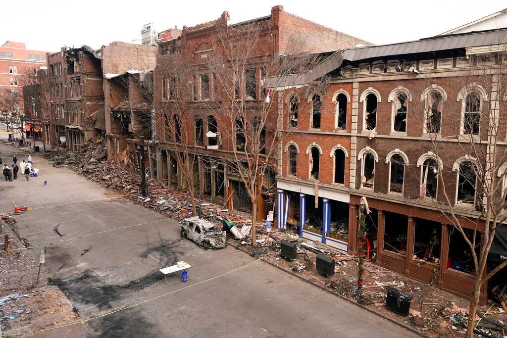Debris remains on the sidewalks in front of buildings damaged in a Christmas Day explosion Tuesday, Dec. 29, 2020, in Nashville, Tenn.