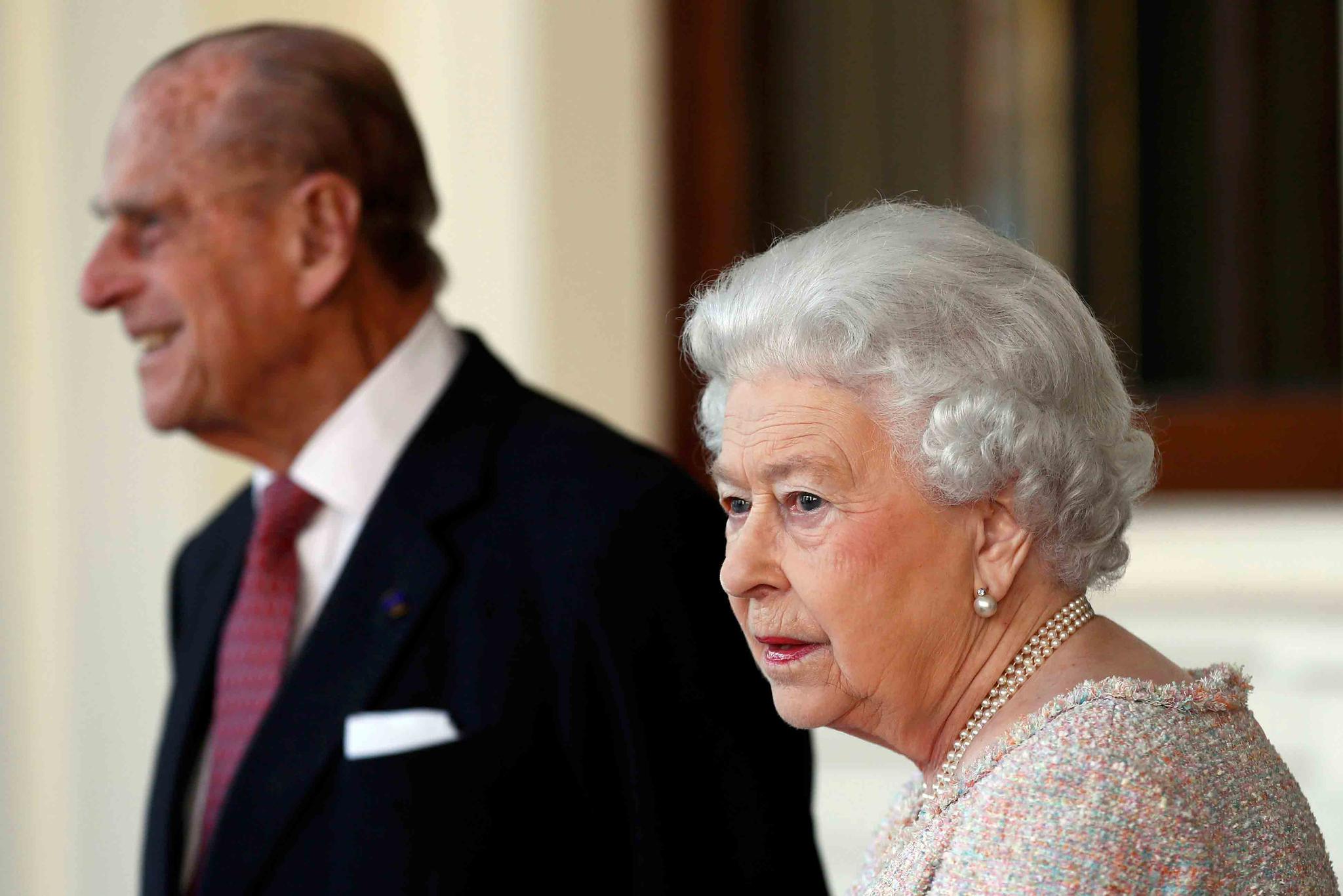 Thursday, Nov. 3, 2016 file photo, Britain's Prince Philip and Queen Elizabeth II bid farewell to Colombia's President Juan Manuel Santos, and his wife Maria Clemencia de Santos, following their state visit, at Buckingham Palace in London.
