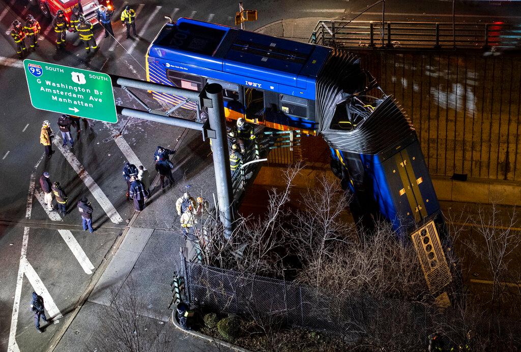 A bus in New York City which careened off a road in the Bronx neighborhood of New York is left dangling from an overpass Friday, Jan. 15, 2021, after a crash late Thursday that left the driver in serious condition, police said.