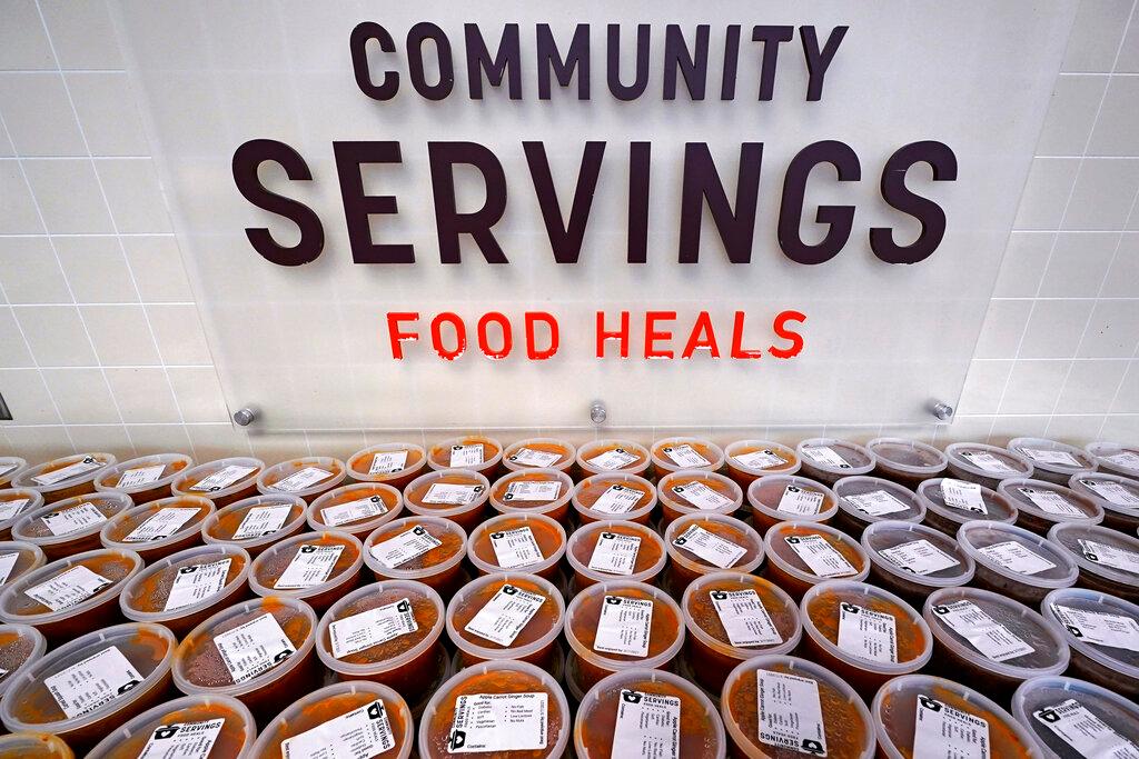 Hundreds of containers of soup are prepared for clients at Community Servings, which prepares and delivers scratch-made, medically tailored meals to individuals & families living with critical & chronic illnesses, Tuesday, Jan. 12, 2021, in the Jamaica Plain neighborhood of Boston. Food is a growing focus for insurers as they look to improve the health of the people they cover and cut costs. Insurers first started covering Community Servings meals about five years ago, and CEO David Waters says they now cover close to 40%.