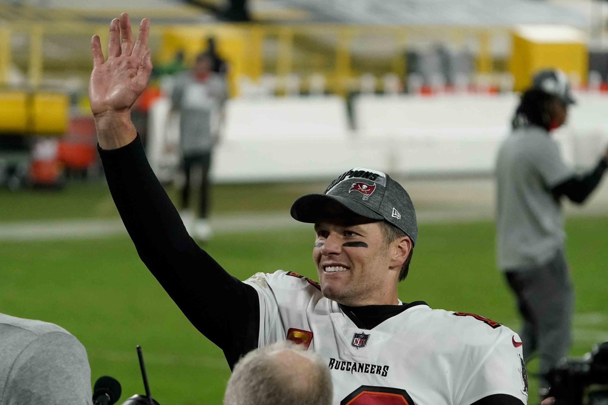 Tampa Bay Buccaneers quarterback Tom Brady waves to spectators after winning the NFC championship NFL football game against the Green Bay Packers in Green Bay, Wis., Sunday, Jan. 24, 2021.