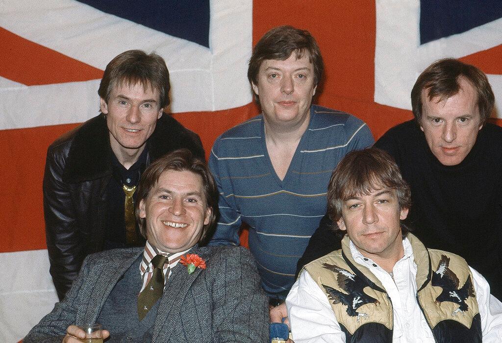In this April 7, 1983 file photo, British pop group The Animals, from left, Hilton Valentine, Chas Chandler, John Steel, front row, Alan Price, and Eric Burdon, pose for photographers after announcing plans for a world tour, in London, England. Hilton Valentine, the founding guitarist of English rock and roll band The Animals who is credited with coming up with one of the most famous opening riffs of the 1960s, has died. He was 77. The band’s label ABKCO Music confirmed that Valentine died on Friday, Jan. 29, 2021 saying it was informed of the death by his wife Germaine Valentine.