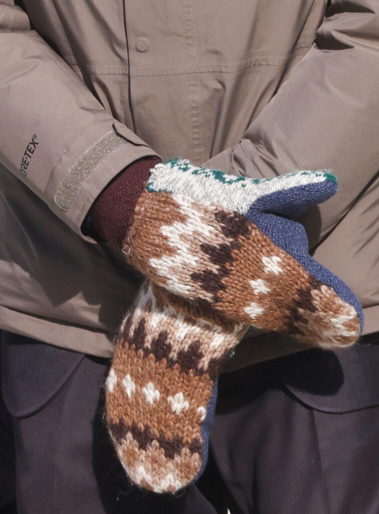 In this Jan. 20, 2021 file photo, Sen. Bernie Sanders, I-Vt., wears mittens as he attends President Joe Biden's inauguration ceremony at the U.S. Capitol in Washington. Sanders says the wooly mittens he wore to the ceremony that sparked endless quirky memes across social media have helped to raise $1.8 million in the last five days for charitable organizations in his home state of Vermont through the sale of T-shirts, sweatshirts and stickers with the iconic image of him sitting with his arms and legs crossed in his brown parka and recycled wool mittens