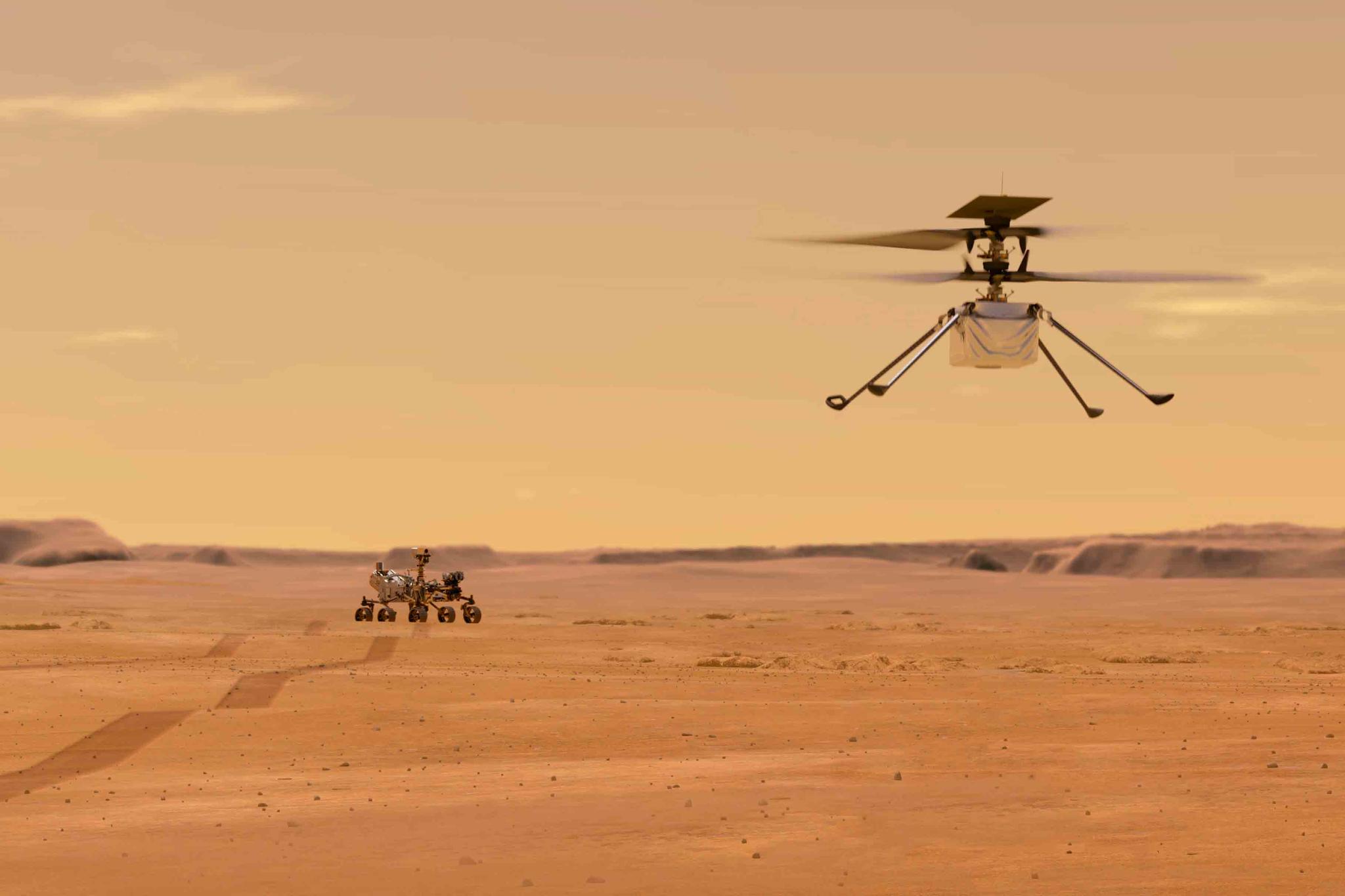 This illustration made available by NASA depicts the Ingenuity helicopter on Mars after launching from the Perseverance rover, background left.