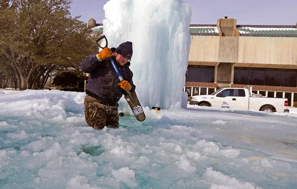 City of Richardson, Texas worker breaks ice on a frozen fountain