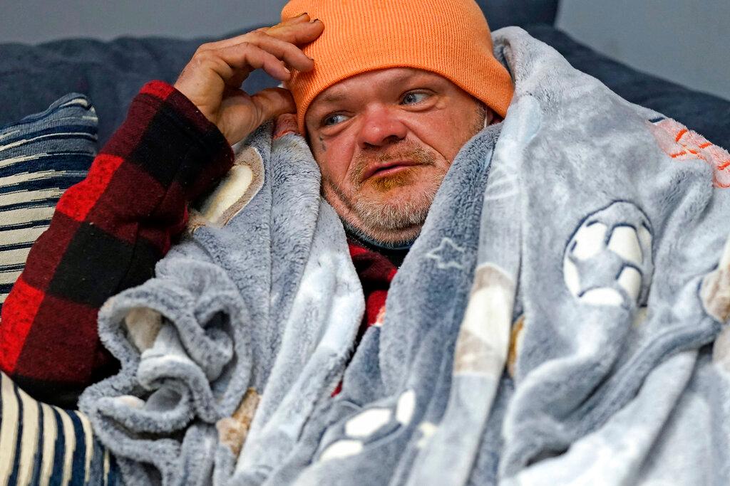 Brett Saint rests inside a Gallery Furniture store which opened as a shelter for those in need of food, water and heat in Houston