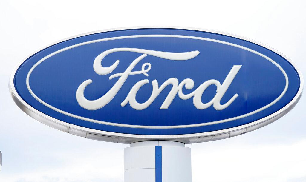 Company logo viewed on sign outside Ford dealership, in Centennial, Colorado