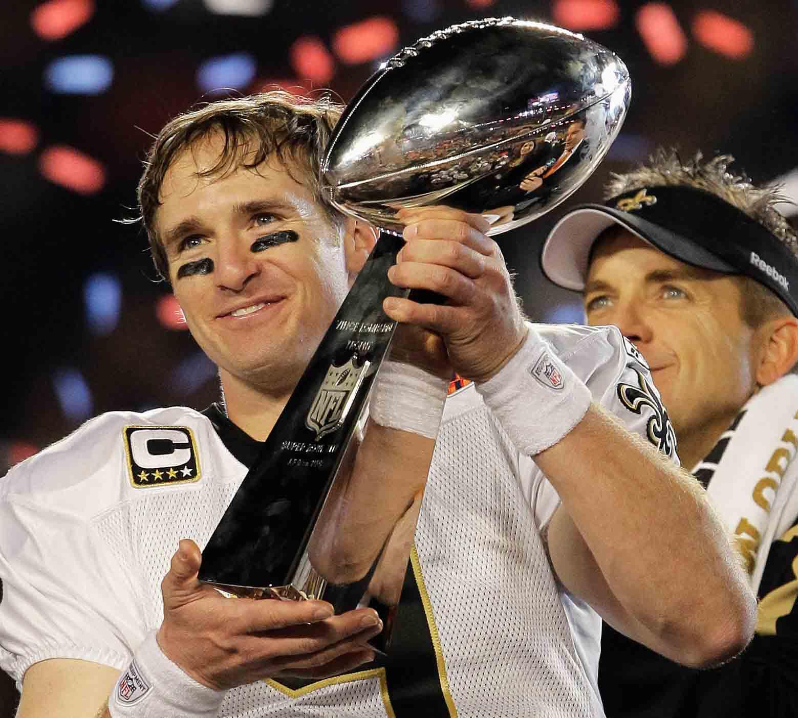 New Orleans Saints quarterback Drew Brees (9) celebrating with the Vince Lombardi Trophy after the Saints' 31-17 win over the Indianapolis Colts in the NFL Super Bowl XLIV football game in Miami.