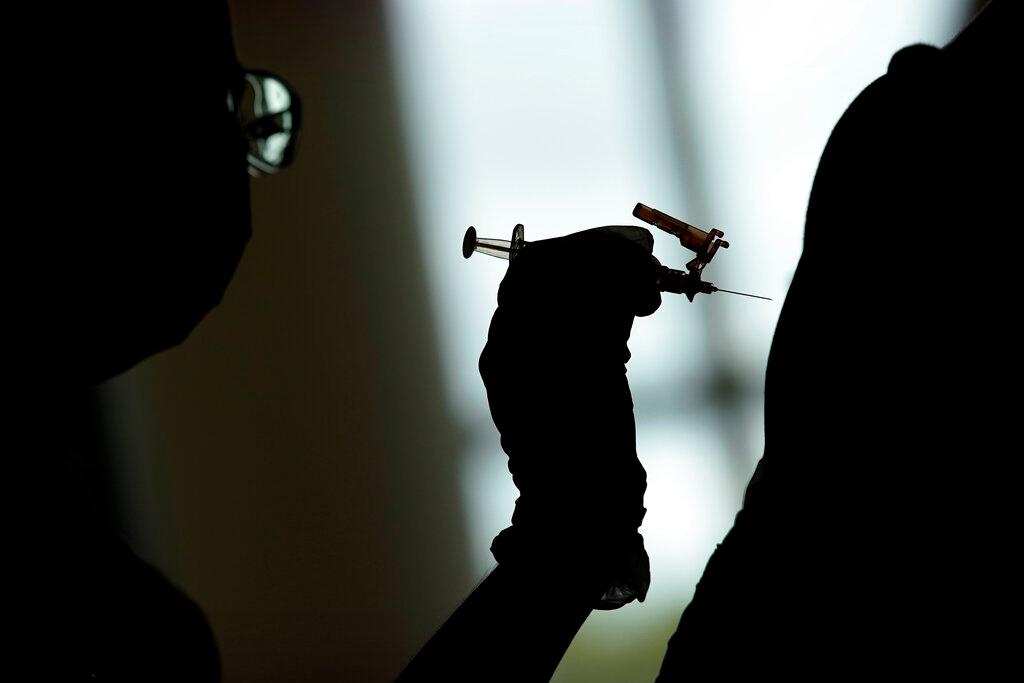 Nursing student administers the Moderna COVID-19 vaccine at a vaccination center at UNLV in Las Vegas