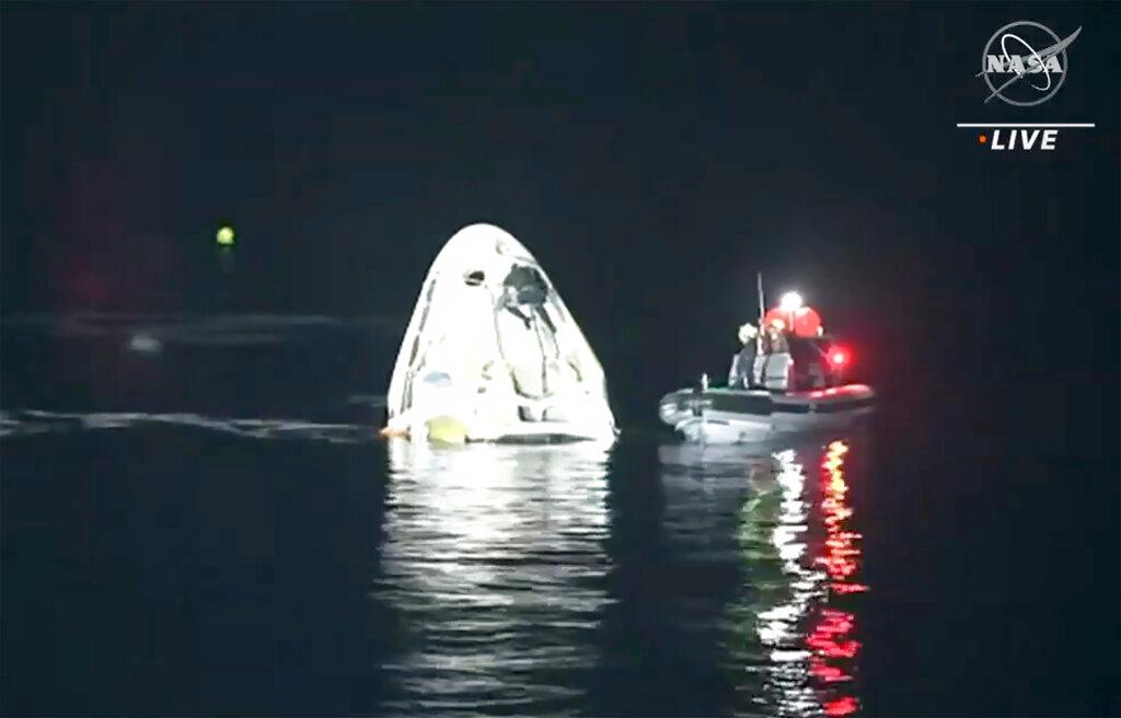 In this image made from NASA TV video, the SpaceX Dragon capsule floats after landing in the Gulf of Mexico near the Florida Panhandle early Sunday, May 2, 2021. SpaceX returned four astronauts from the International Space Station on Sunday, making the first U.S. crew splashdown in darkness since the Apollo 8 moonshot.