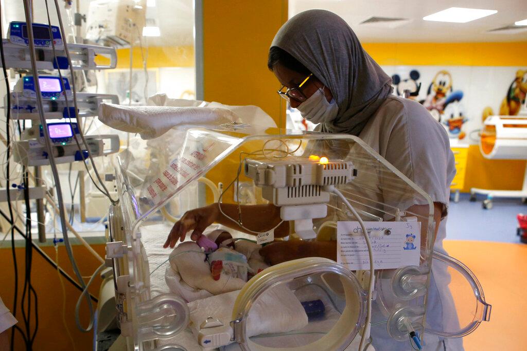 A Moroccan nurse takes care of one of the nine babies protected in an incubator at the maternity ward of the private clinic of Ain Borja in Casablanca, Morocco