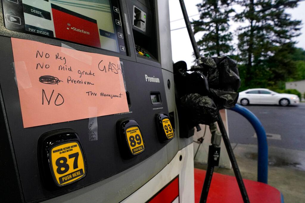 A hand written sign is posted on a gas pump, showing that the service station is out of all grades of fuel Wednesday, May 12, 2021, in Charlotte, N.C. Several gas stations in the Southeast reported running out of fuel, primarily because of what analysts say is unwarranted panic-buying among drivers, as the shutdown of a major pipeline by hackers entered its fifth day.