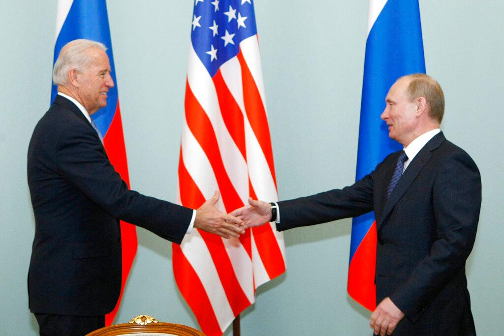 Biden and Putin shake hands in 2011