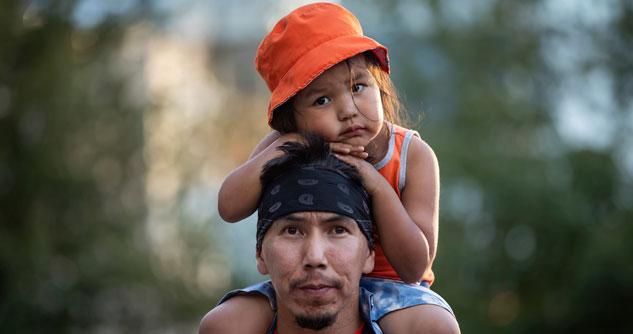 Man with three-year-old child on shoulders