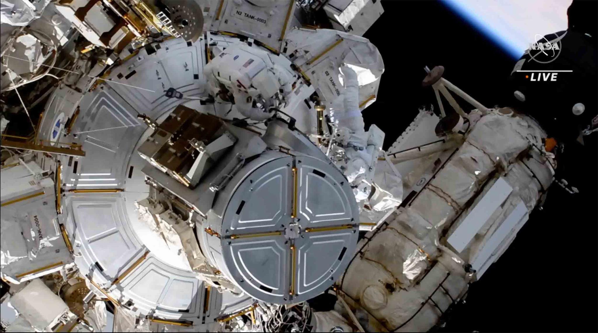 This photo provided by NASA shows astronauts NASA's Shane Kimbrough and France's Thomas Pesquet during a space walk outside the International Space Station on Friday, June 25, 2021.