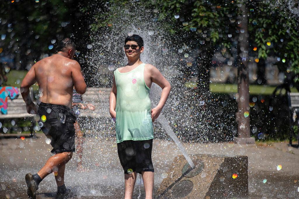 Portland, Ore., reached a record temperature of over 110 degrees, people gathered at Salmon Street Springs water fountain in Portland to cool off. 