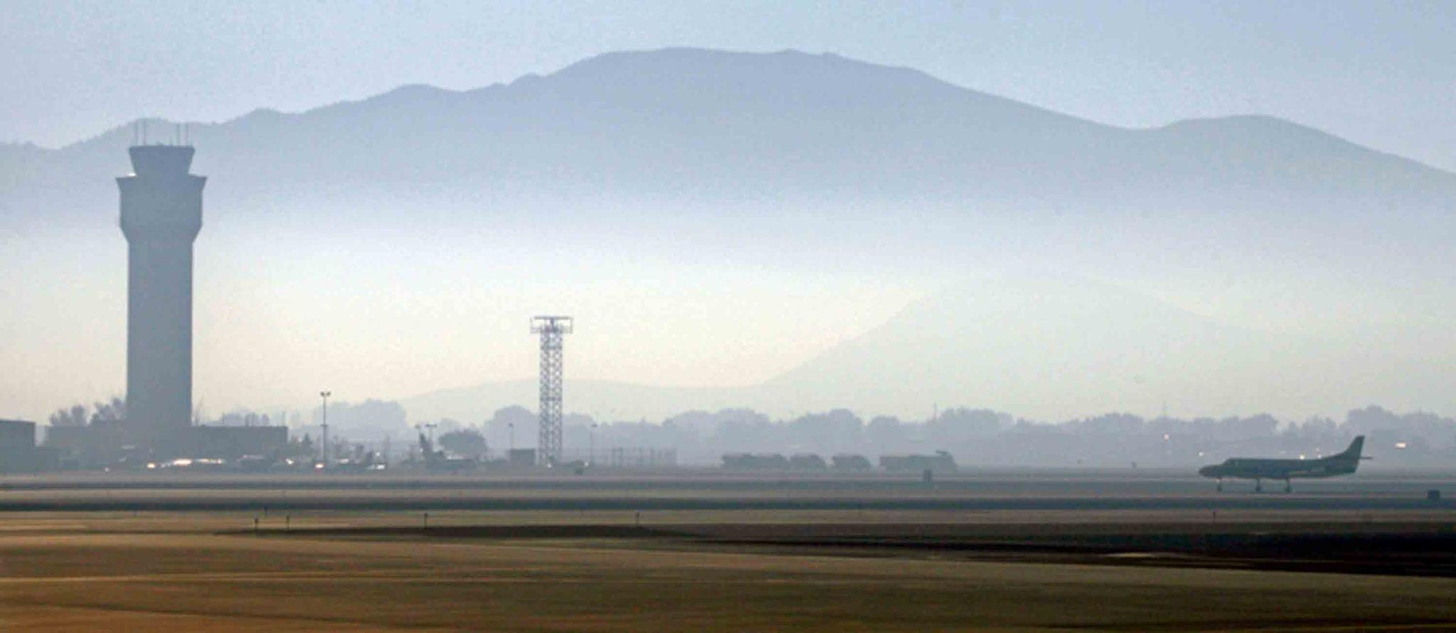 In this Sept. 24, 2014 file photo, smoke hangs over Reno-Tahoe International Airport as a plane takes off in Reno, Nev. A shortage of jet fuel, coupled with supply chain issues and an urgent demand from firefighting aircraft, continues to cause problems at airports around the West.