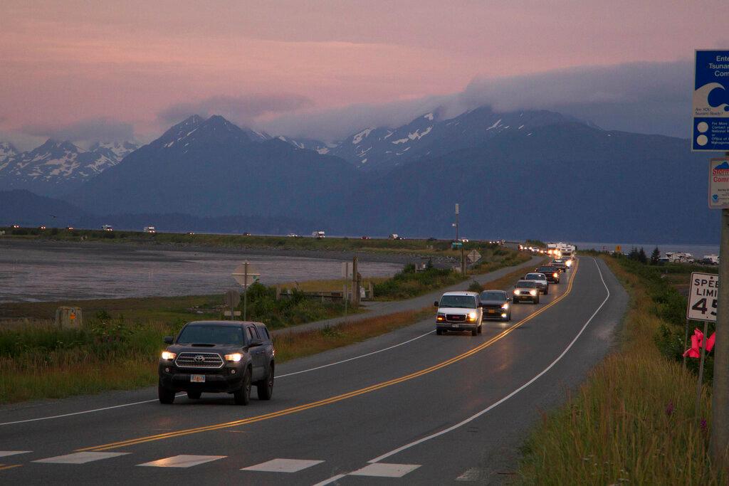 A line of cars evacuates the Homer Spit in Homer, Alaska on July 28, 2021, after a tsunami warning was issued following a magnitude 8.2 earthquake