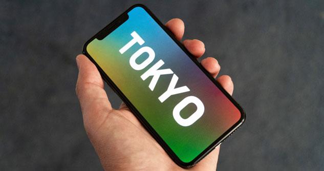 A cell phone with Tokyo as a screensaver