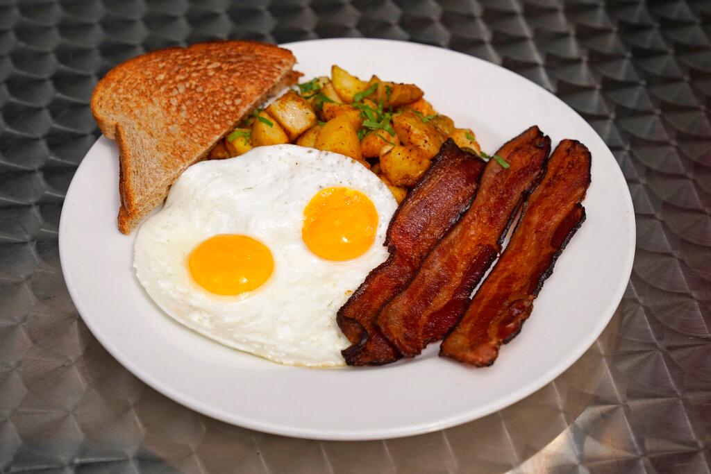 Jeannie Kim's popular bacon and eggs breakfast is seen outside her restaurant in San Francisco on Friday, July 30, 2021. Thanks to a reworked menu and long hours, Jeannie Kim managed to keep her San Francisco restaurant alive during the coronavirus pandemic. That makes it all the more frustrating that she fears her breakfast-focused diner could be ruined within months by new rules that could make one of her top menu items — bacon — hard to get in California.