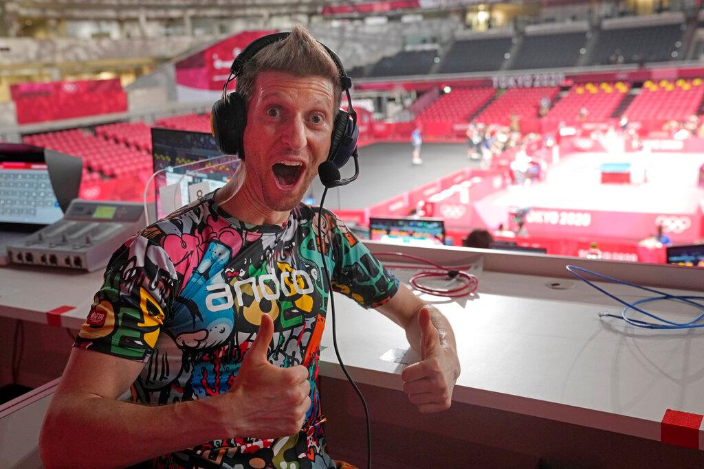 Adam Bobrow, lead commentator for the International Table Tennis Federation, poses for a photograph during the table tennis men's team semifinal between Germany and Japan at the 2020 Summer Olympics