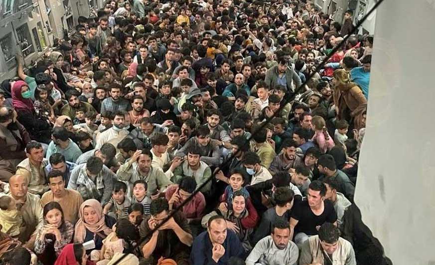 Afghan citizens pack inside a U.S. Air Force C-17 Globemaster III, as they are transported from Hamid Karzai International Airport in Afghanistan, Sunday