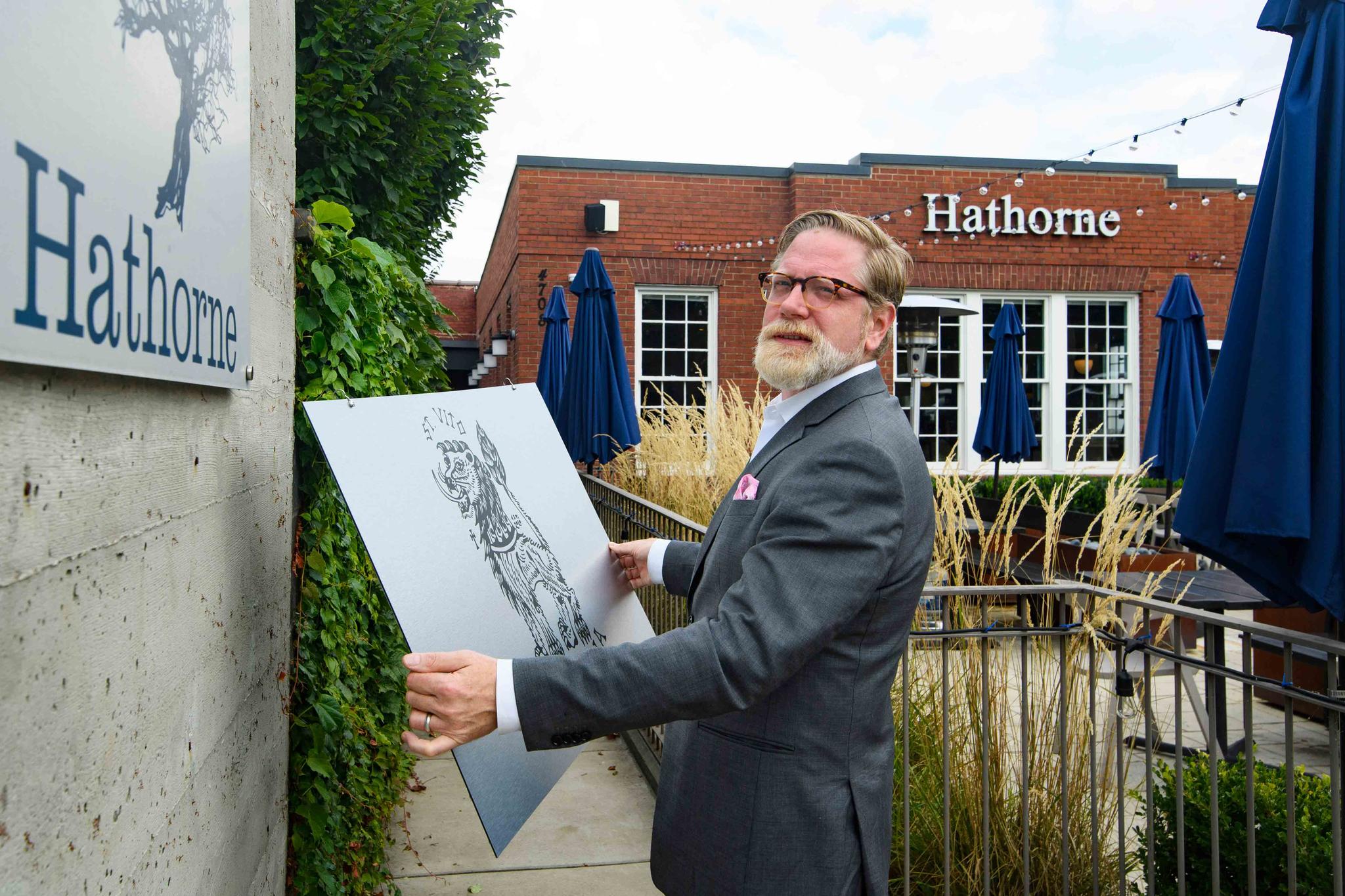 Hathorne restaurant owner John Stephenson holds a sign for a pop-up restaurant which will cover the Hathorne sign when that restaurant is open, Wednesday, Aug. 18, 2021, in Nashville, Tenn.