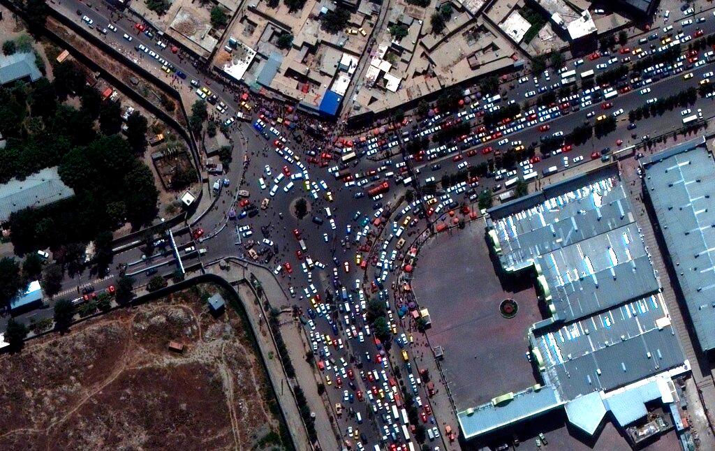 This satellite image provided by Maxar Technologies shows crowds and traffic at the entrance to Kabul’s international airport