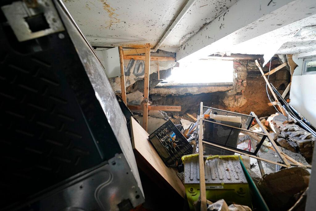 A hole in the foundation where a window once was and flood waters rushed in is seen in the basement apartment in Queens, NYC