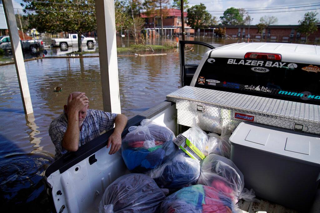 Man rests while helping neighbors in damaged home from Hurricane Ida 
