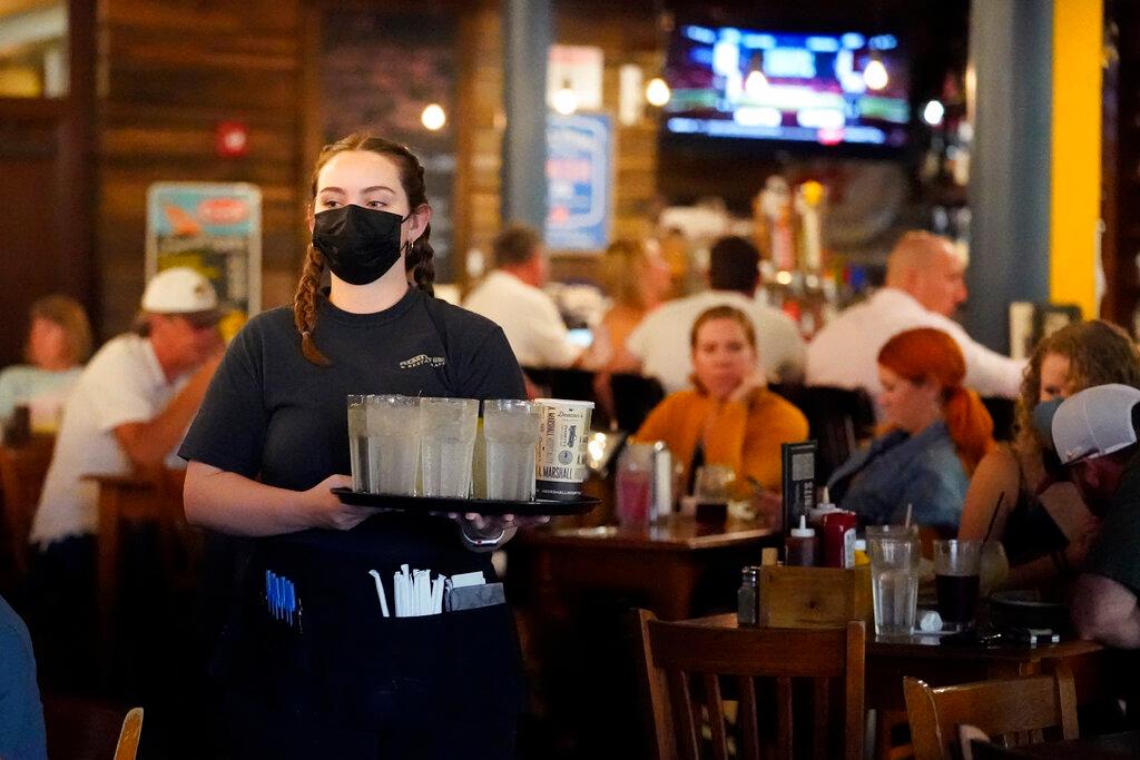 Wait staff carries drinks to table at Nashville Restaurant 