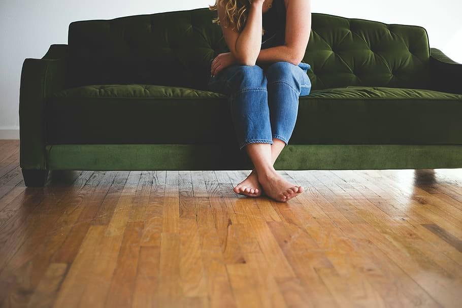 Woman sitting on couch with crossed feet 