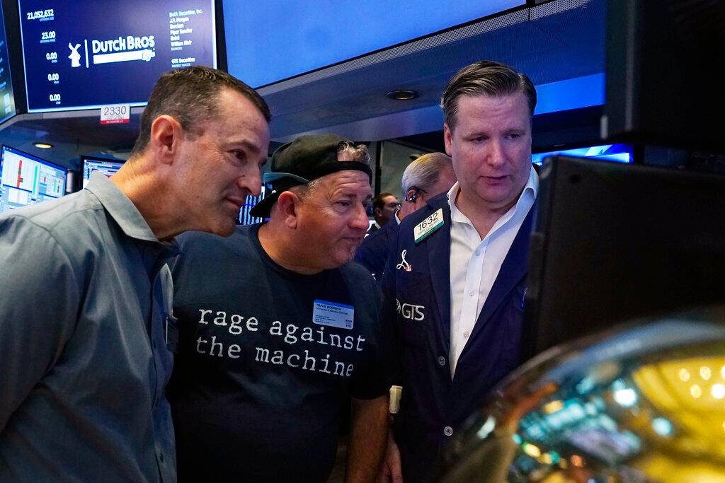 President and CEO of Dutch Bros. Coffee Joth Ricci, left, and Travis Boersma, center. co-Fopunder and President, meet with specialist Gregg Maloney, on the floor of the New York Stock Exchange