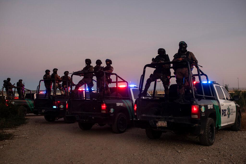 Mexican police stand guard near the Rio Grande river in Ciudad Acuna, Mexico,