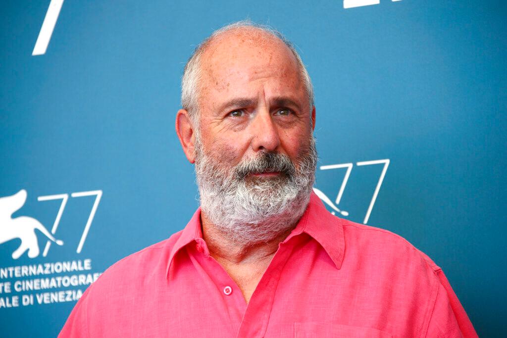 Roger Michell poses for photographers at the photo call for the film 'The Duke' during the 77th edition of the Venice Film Festival in Venice, Italy, on Sept. 4, 2020. Michell, the British stage, television and film director whose movies include the indelibly popular romcom “Notting Hill,” has died, his family said Thursday. He was 65.