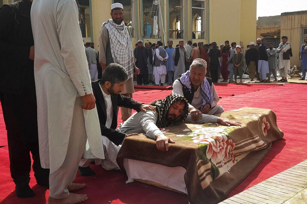 Relatives and residents attend a funeral ceremony for victims of a suicide attack at the Gozar-e-Sayed Abad Mosque in Kunduz, northern Afghanistan,