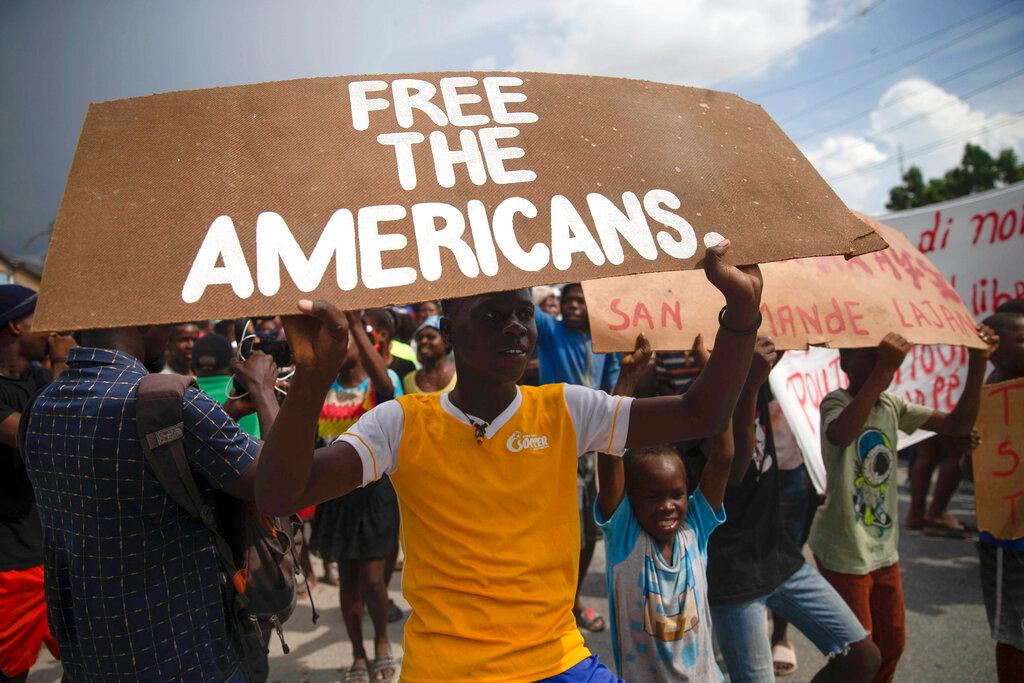 People protest for the release of kidnapped missionaries near the missionaries' headquarters in Titanyen, north of Port-au-Prince, Haiti