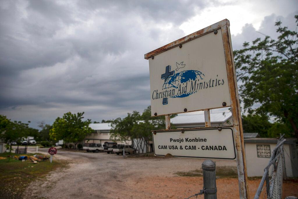 A custom sign stands outside Christian Aid Ministries in Titanyen, north of Port-au-Prince, Haiti
