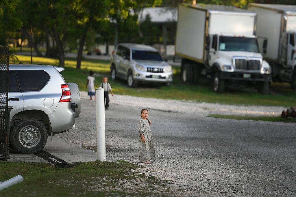 A child stands on the grounds of the Christian Aid Ministries headquarters in Titanyen, Haiti, Thursday, Oct. 21, 2021. The leader of the 400 Mawozo gang that police say is holding 17 members of missionary group is seen in a video released Thursday saying he will kill them if he doesn’t get what he’s demanding.