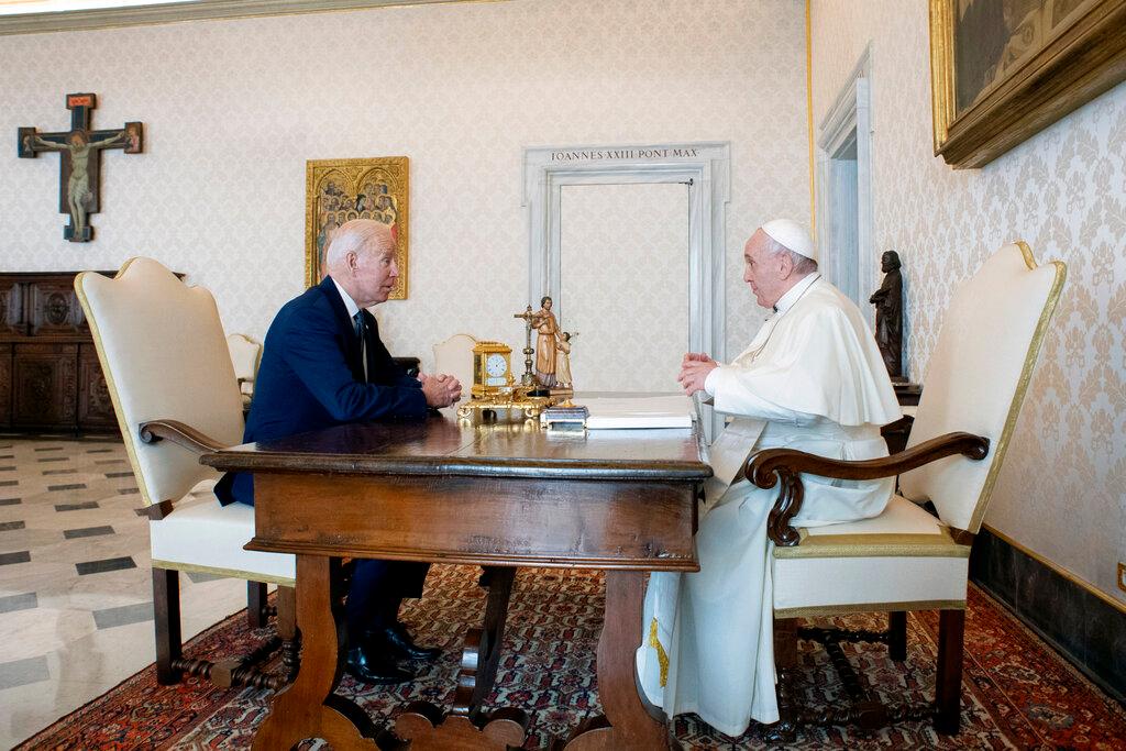 President Joe Biden, left, talks with Pope Francis as they meet at the Vatican