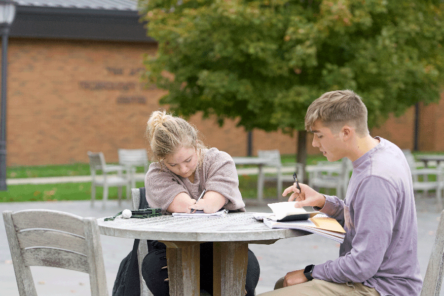 Marissa studies on the outdoor patio