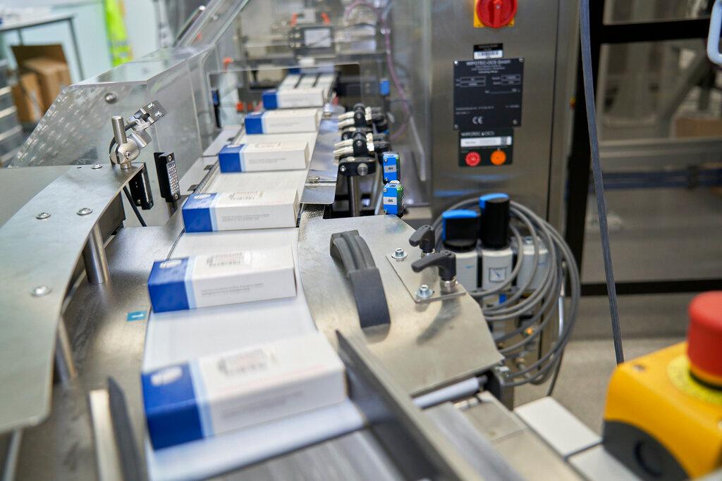 This image provided by Pfizer shows boxes for its COVID-19 pill.
