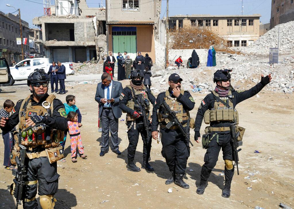 Iraqi security officials clear the road 