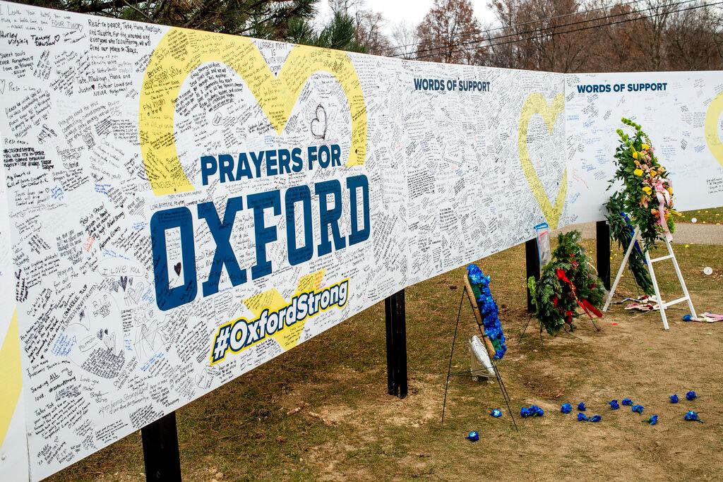  Handwritten messages are left at the memorial site at the memorial site on Tuesday, Dec. 7, 2021, outside Oxford High School in Oxford, Mich.