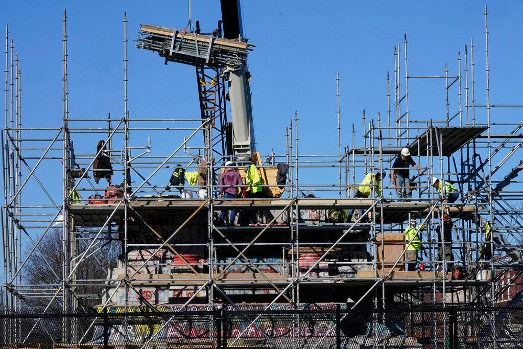 Workers continue to dismantle the pedestal that once held the statue of Confederate General Robert E. Lee on Monument Avenue
