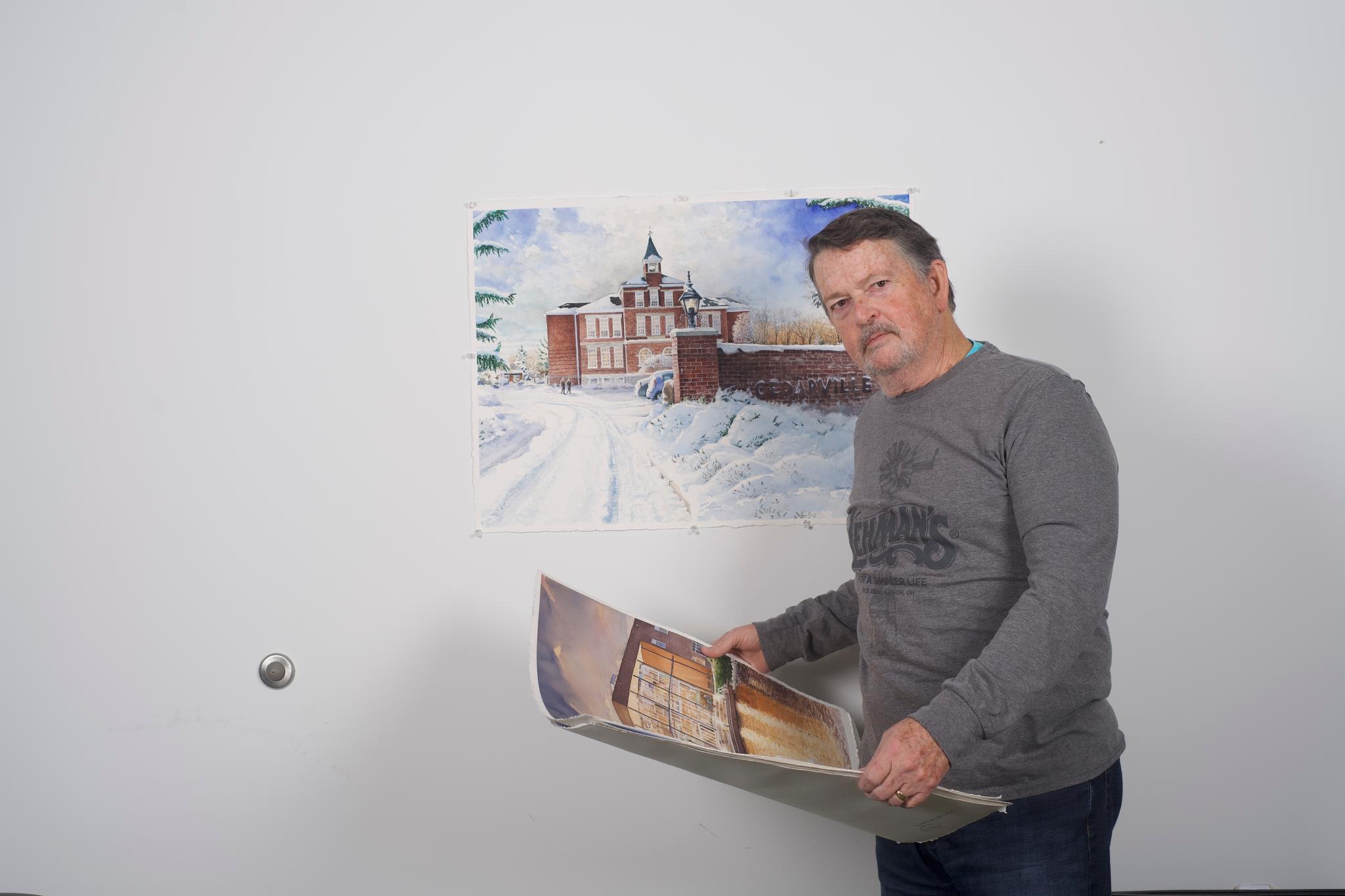 Clevenger next to his snowscape of Founders Hall