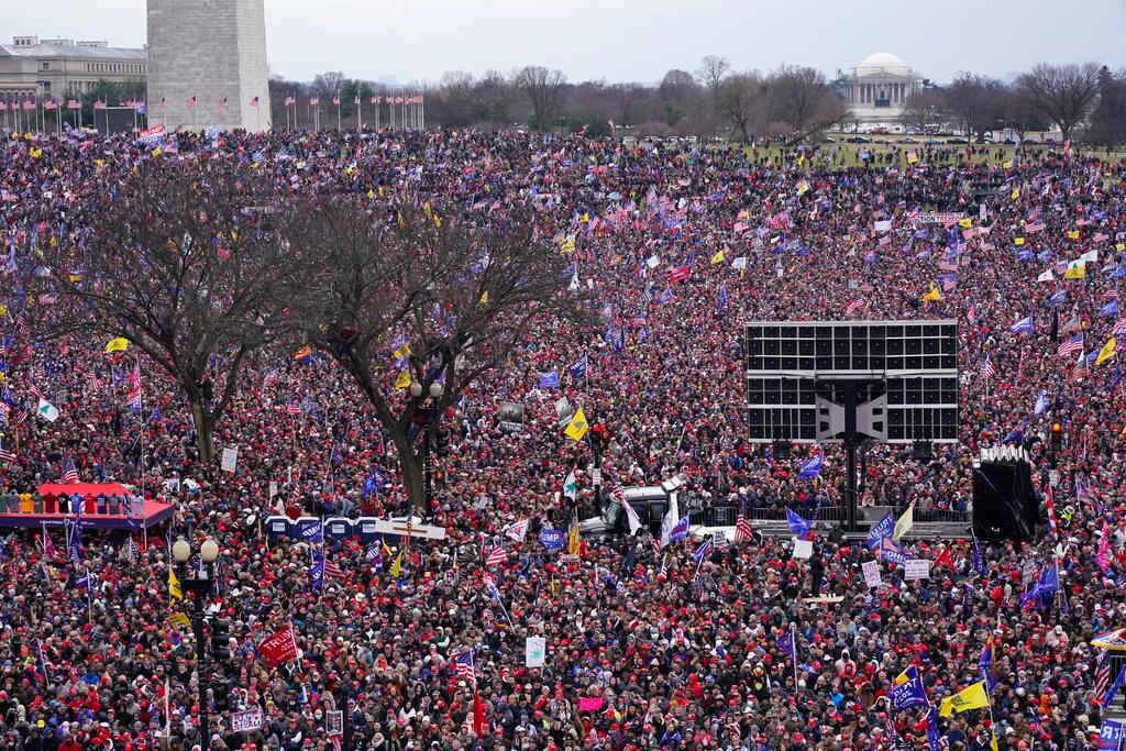 With the Washington Monument in the background, people attend a rally in support of President Donald Trump near the White House on Jan. 6, 2021, in Washington.