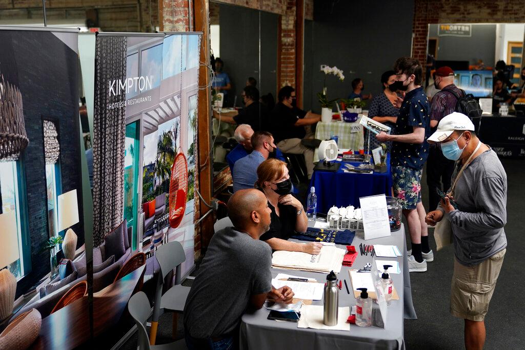 Prospective employers and job seekers interact during during a job fair on Sept. 22, 2021, in the West Hollywood section of Los Angeles. Hiring in California slowed significantly in November 2021 even as the state's unemployment rate dipped below 7% for the first time since March 2020, at the start of the pandemic, according to data made public Friday, Dec. 17, 2021.