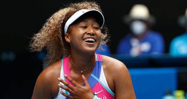 Female tennis player with white nike visor, smiling